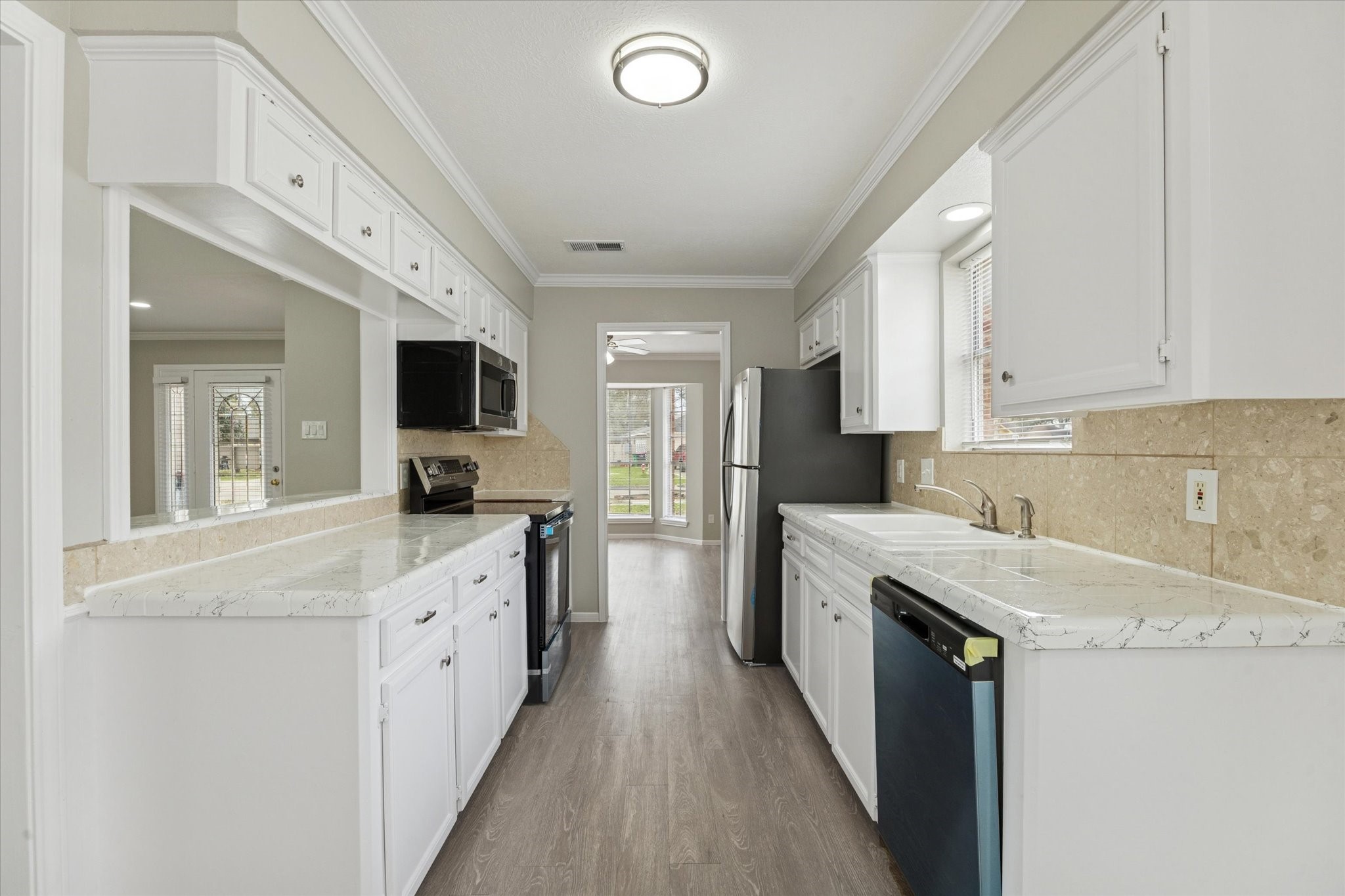 23834 English Oak Drive Spring, TX 77373 - Photo 2 of 11 a kitchen with granite countertop a sink and stainless steel appliances