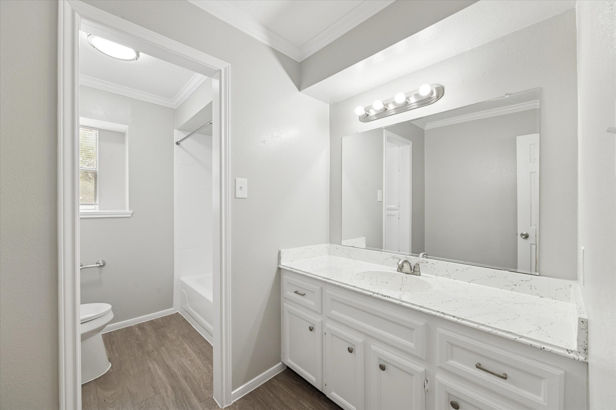 23834 English Oak Drive Spring, TX 77373 - Photo 9 of 11 a bathroom with a double vanity sink a toilet and a mirror