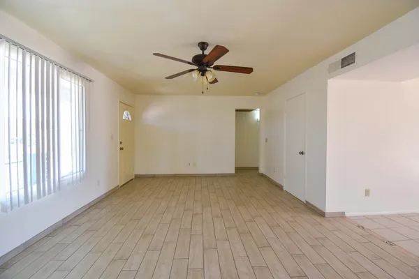 a view of a livingroom with a ceiling fan and window