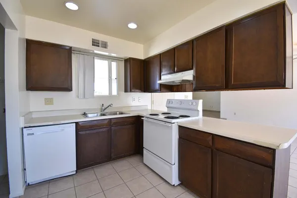 a kitchen with a sink cabinets and appliances