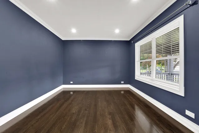 a view of a room with wooden floor and windows