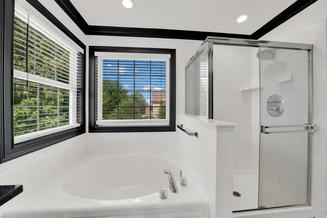 a bathroom with a bathtub and a shower