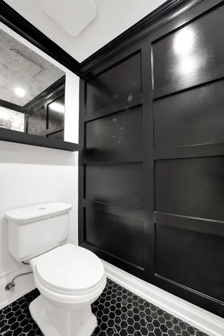 a bathroom with a toilet and a shower