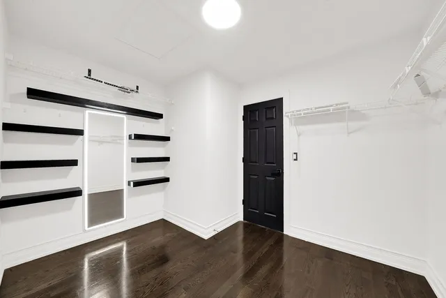 a view of walk in closet with empty racks