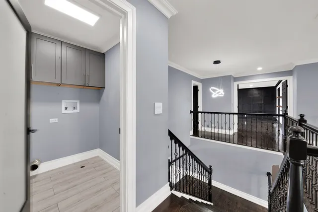 a view of a hallway with wooden floor and windows