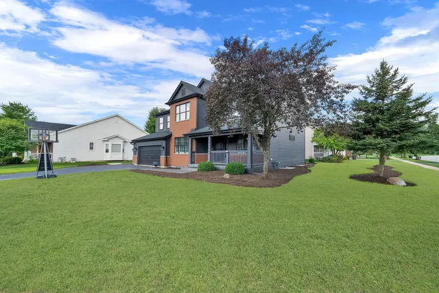 a front view of a house with a garden and deck