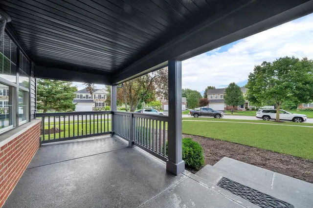 a view of a porch with a floor to ceiling window and wooden fence