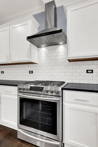a stove top oven sitting inside of a kitchen