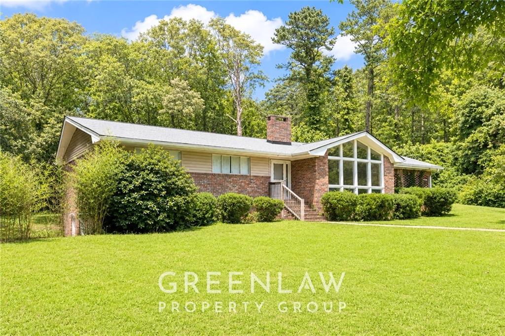 3605 Flat Shoals Road Atlanta, GA 30349 - Photo 2 of 35 a front view of a house with a yard