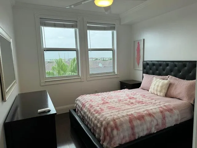 a bed sitting in a bedroom next to a window