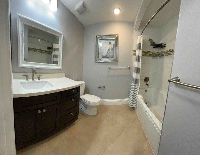 1660 Renaissance Commons Boulevard, Unit 2619 Boynton Beach, FL 33426 - Photo 10 of 20 a bathroom with a sink a toilet and shower