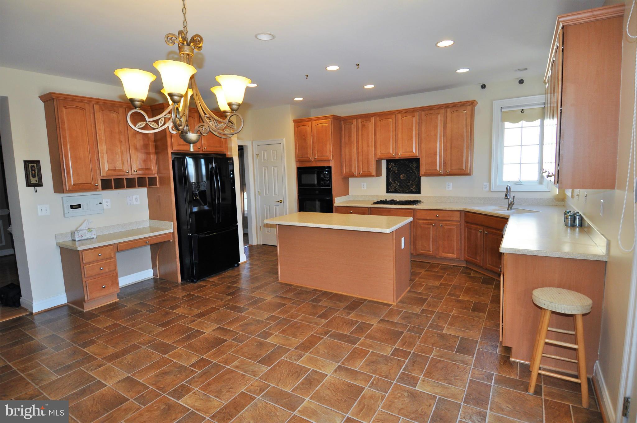 10827 Catron Road Perry Hall, MD 21128 - Photo 2 of 27 a kitchen with stainless steel appliances granite countertop a sink a stove top oven a counter space and cabinets