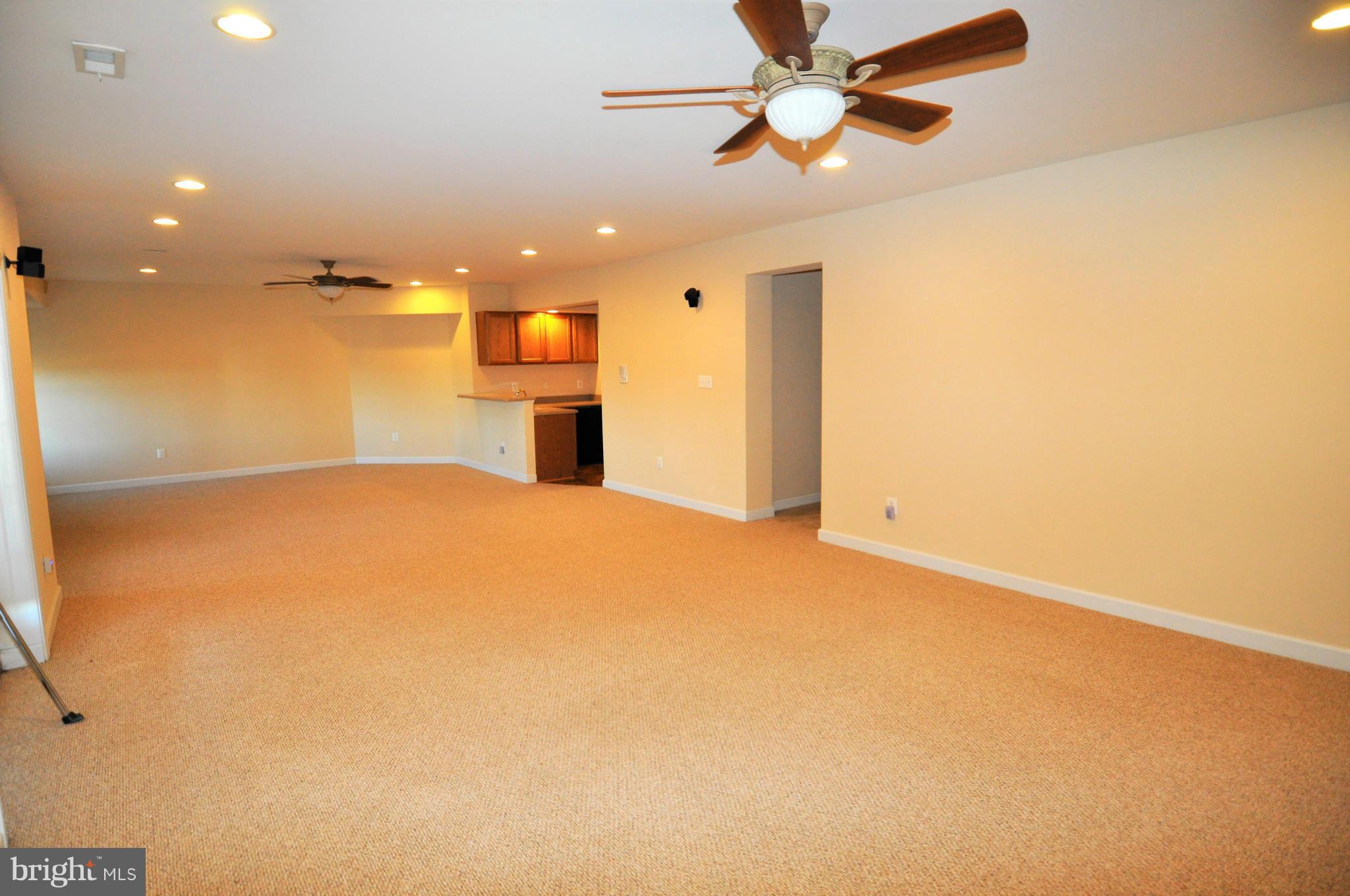 10827 Catron Road Perry Hall, MD 21128 - Photo 15 of 27 a view of a big room with windows and ceiling fan
