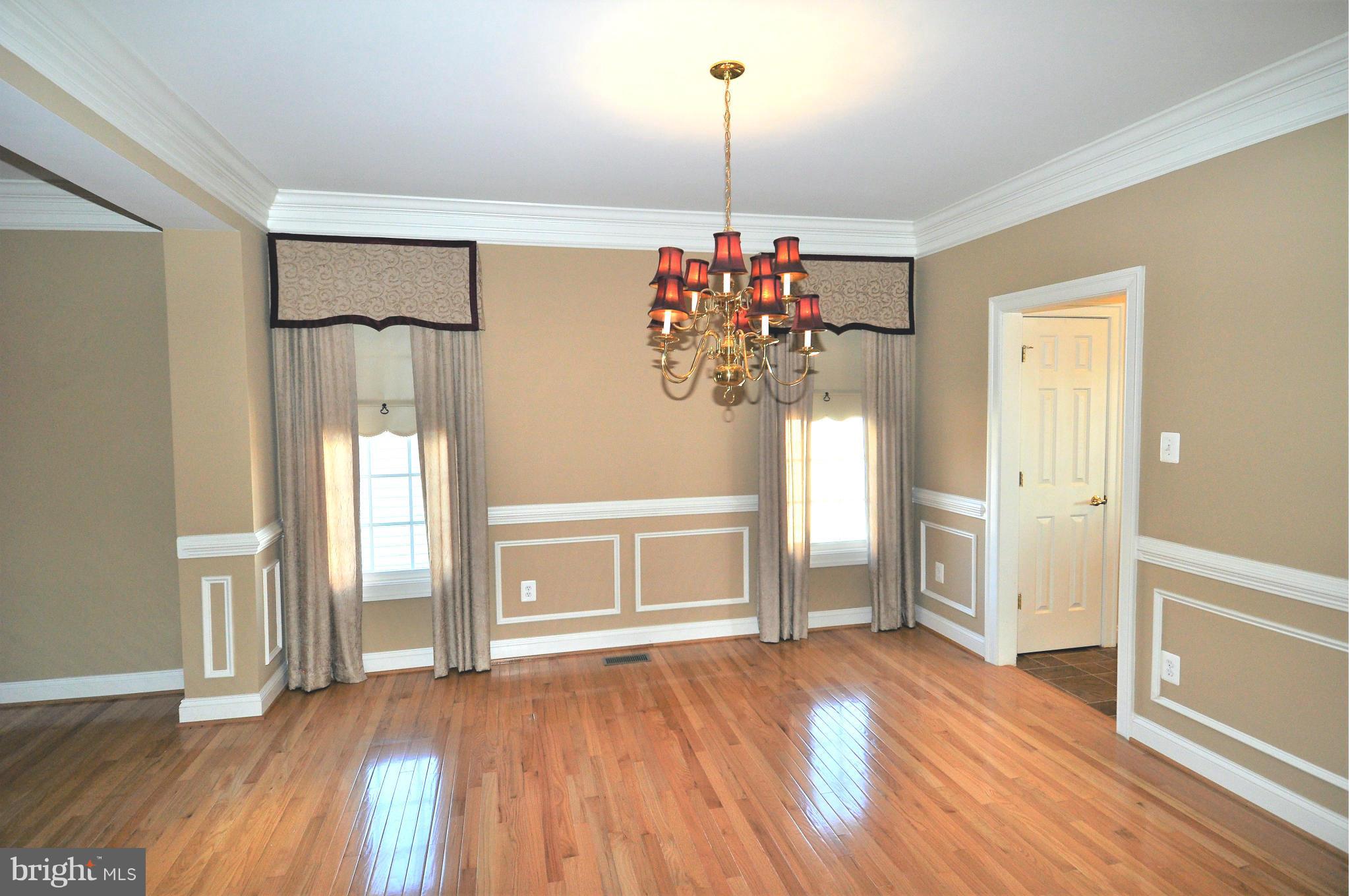 10827 Catron Road Perry Hall, MD 21128 - Photo 4 of 27 a view of an empty room with window and wooden floor