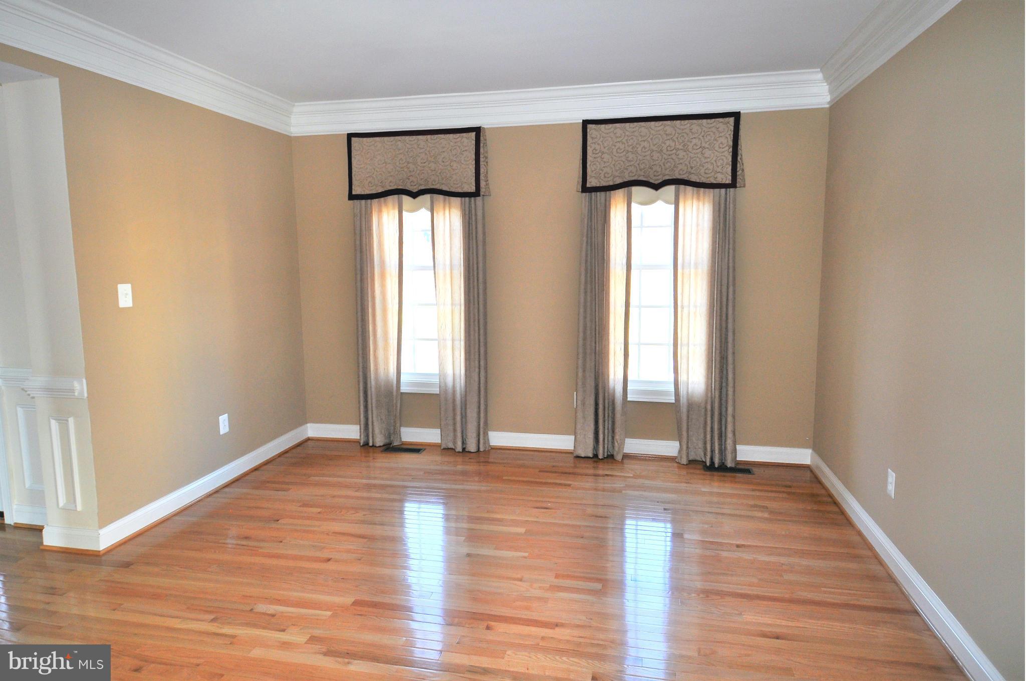 10827 Catron Road Perry Hall, MD 21128 - Photo 5 of 27 a view of an empty room with window and wooden floor