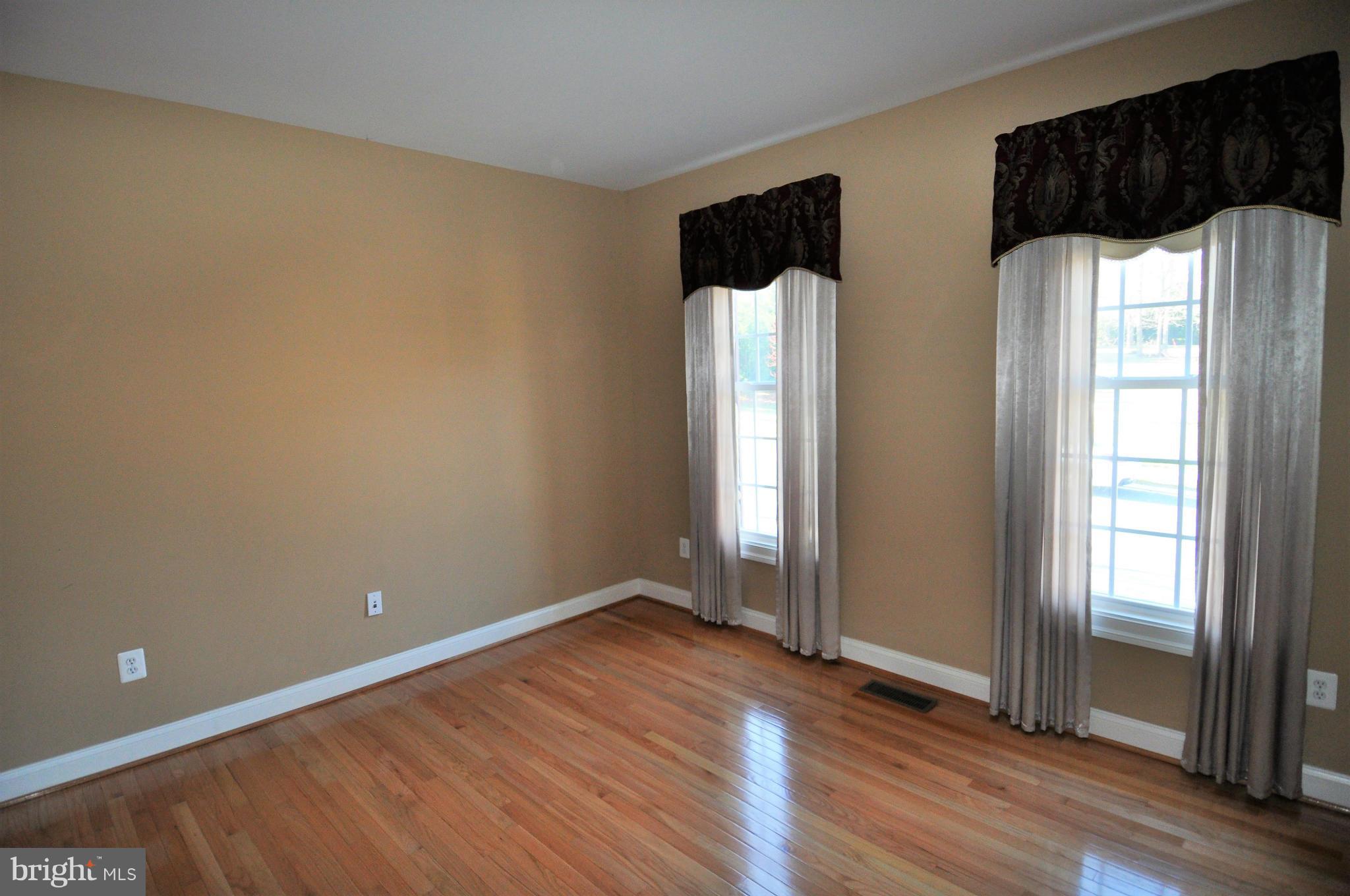 10827 Catron Road Perry Hall, MD 21128 - Photo 8 of 27 an empty room with wooden floor and windows