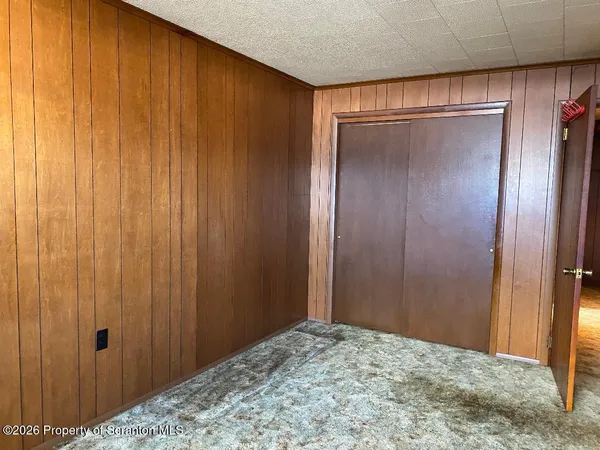 a view of an empty room and a window
