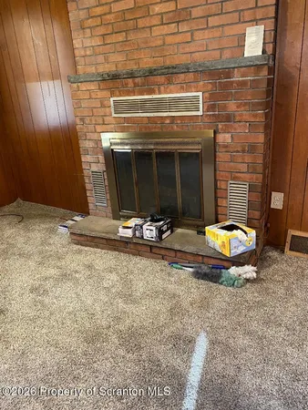 a view of a fireplace with a table in a room