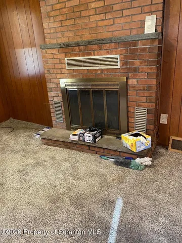 a view of a fireplace with a table in a room