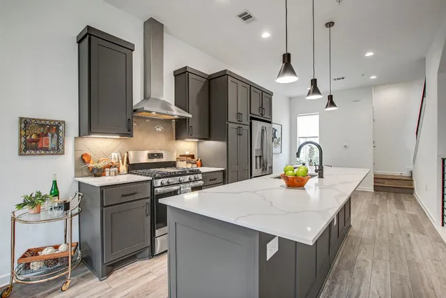 a kitchen with stainless steel appliances a sink a stove and refrigerator