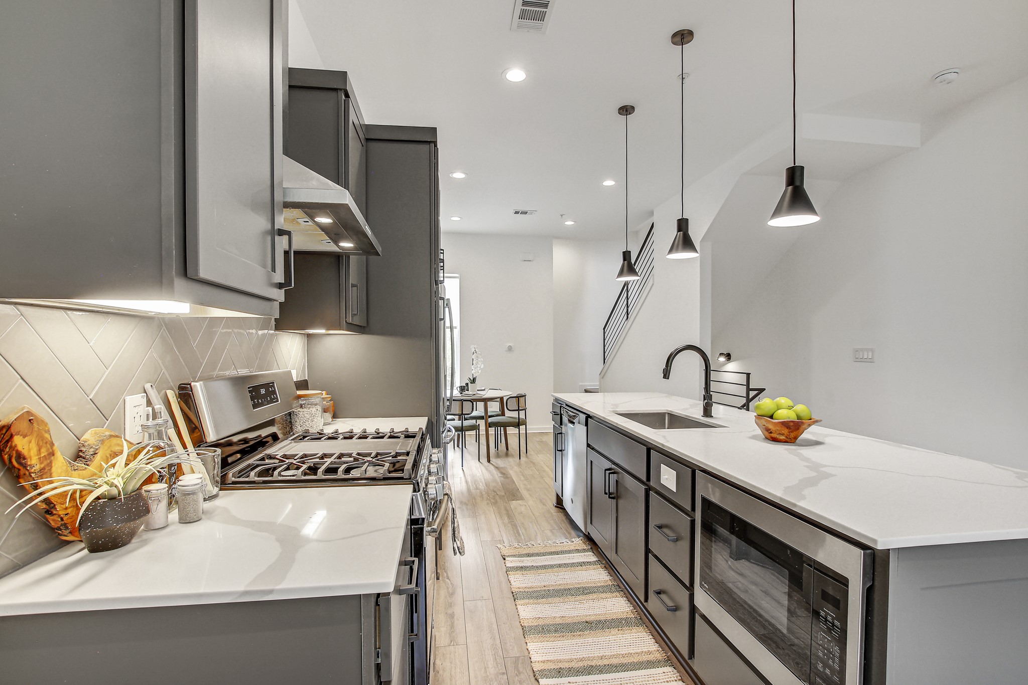 2804 South 1st Street, Unit 1108 Austin, TX 78704 - Photo 16 of 40 a kitchen with a sink a stove and a wooden floor