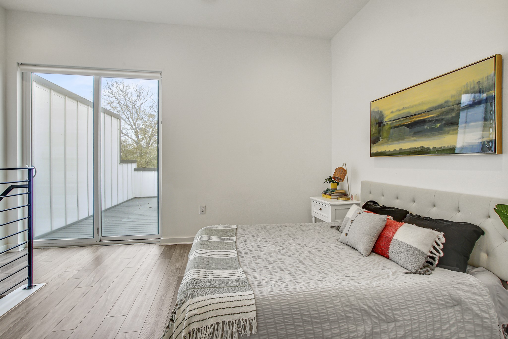 2804 South 1st Street, Unit 1108 Austin, TX 78704 - Photo 17 of 40 a bedroom with a bed and wooden floor