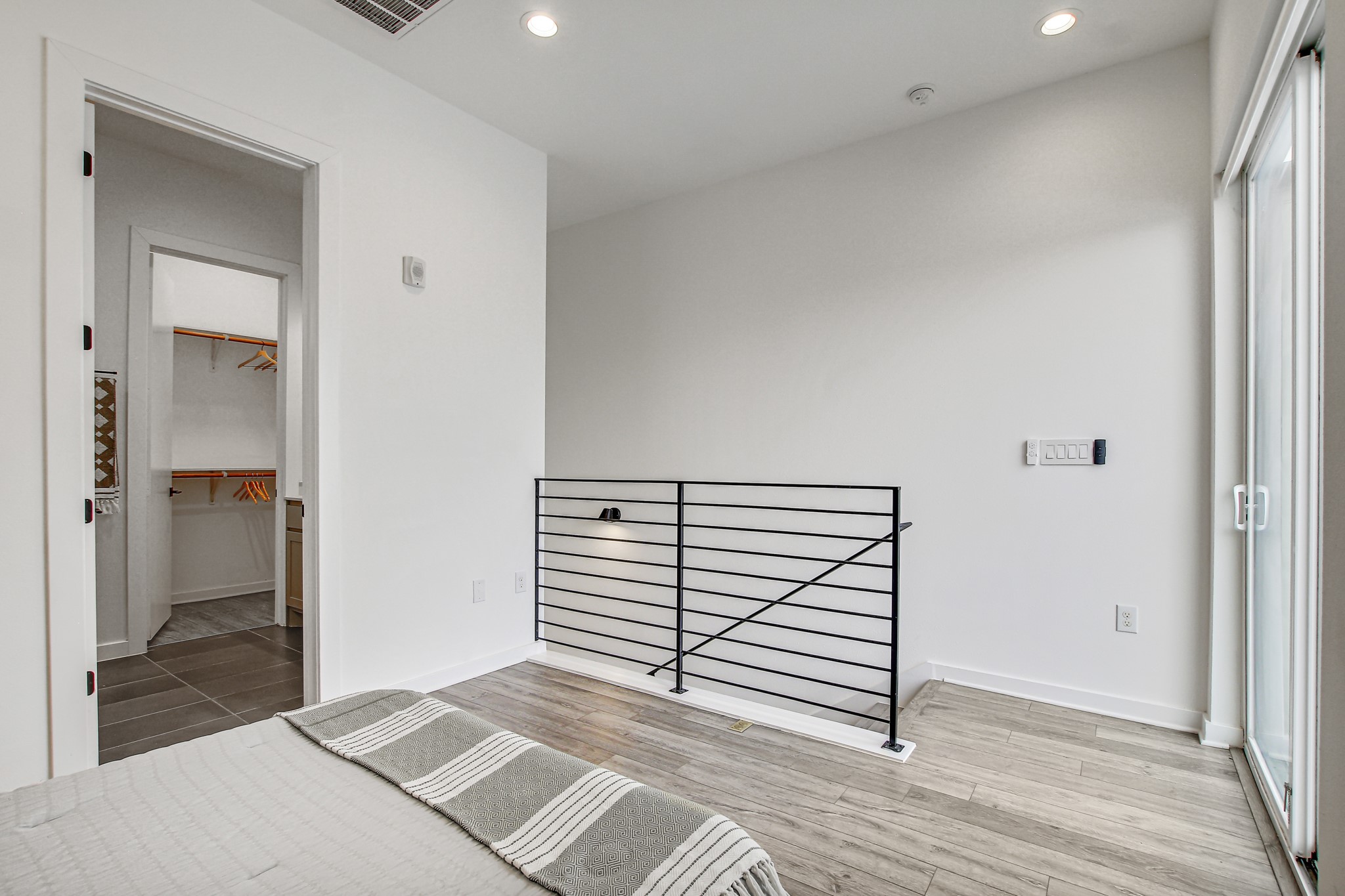 2804 South 1st Street, Unit 1108 Austin, TX 78704 - Photo 18 of 40 a view of a bedroom with wooden floor and bathroom