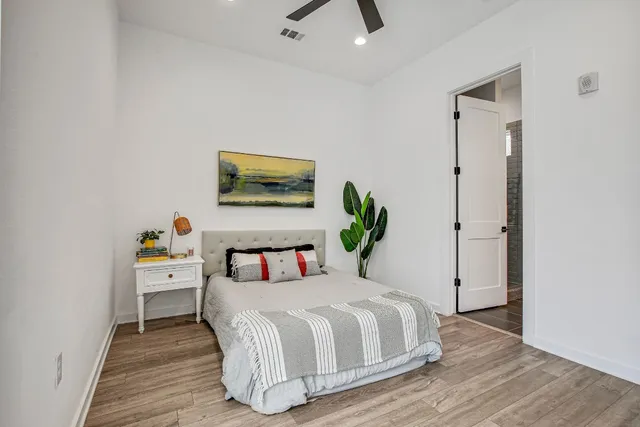 a bedroom with a bed and a table