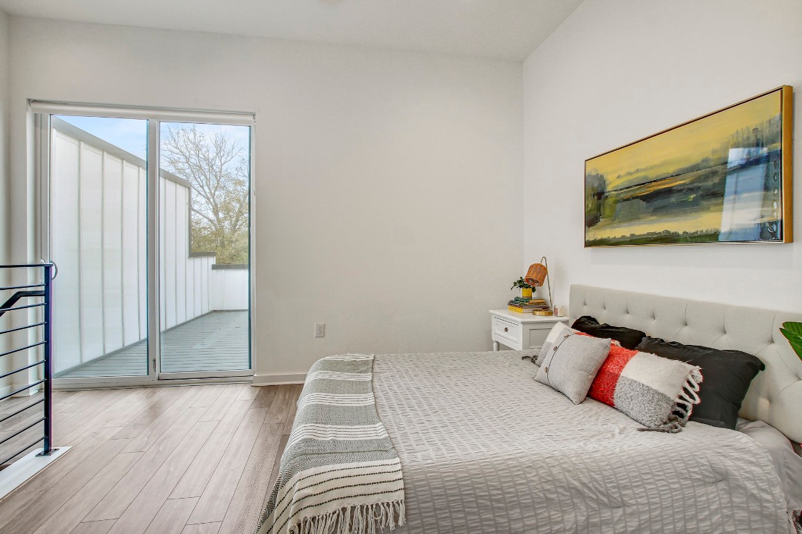 2804 South 1st Street, Unit 1108 Austin, TX 78704 - Photo 21 of 40 a bedroom with a bed and wooden floor