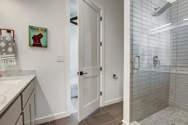a bathroom with a granite countertop sink a vanity and a shower