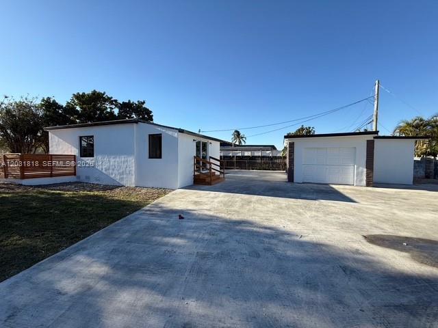 1800 Southwest 75th Avenue Road Miami, FL 33155 - Photo 3 of 17 a front view of a house with a yard and garage