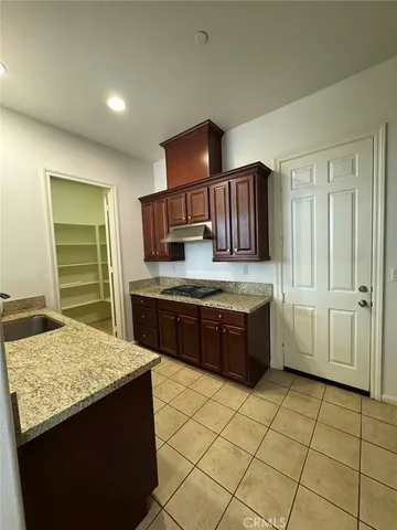 a kitchen with a stove a sink and a refrigerator