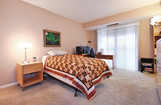 1621 Mission Hills Road, Unit 503 Northbrook, IL 60062 - Photo 9 of 10 a bed sitting in a spacious bedroom next to a window and a lamp