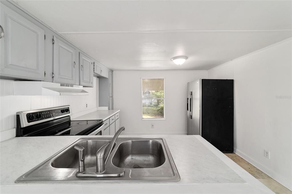 3081 Southwest 90th Street Ocala, FL 34476 - Photo 16 of 34 a kitchen with a sink and a refrigerator