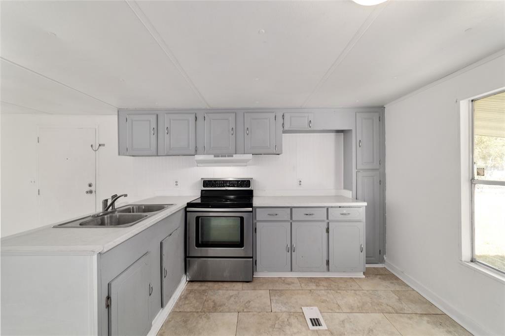 3081 Southwest 90th Street Ocala, FL 34476 - Photo 17 of 34 a kitchen with a sink and cabinets
