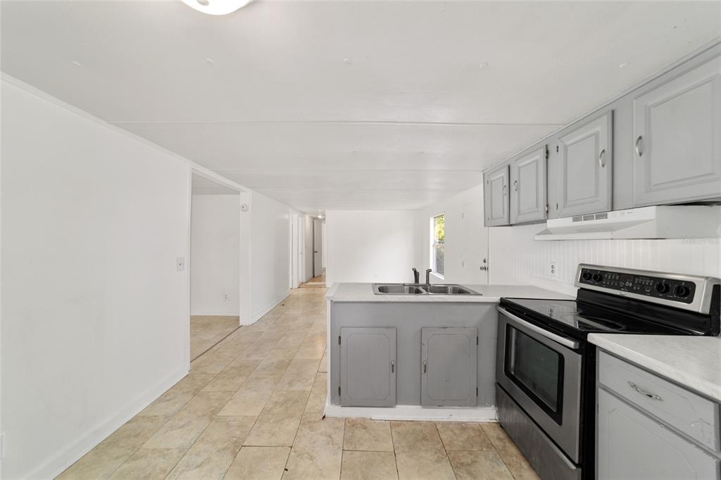 3081 Southwest 90th Street Ocala, FL 34476 - Photo 18 of 34 a kitchen with a sink stove and cabinets