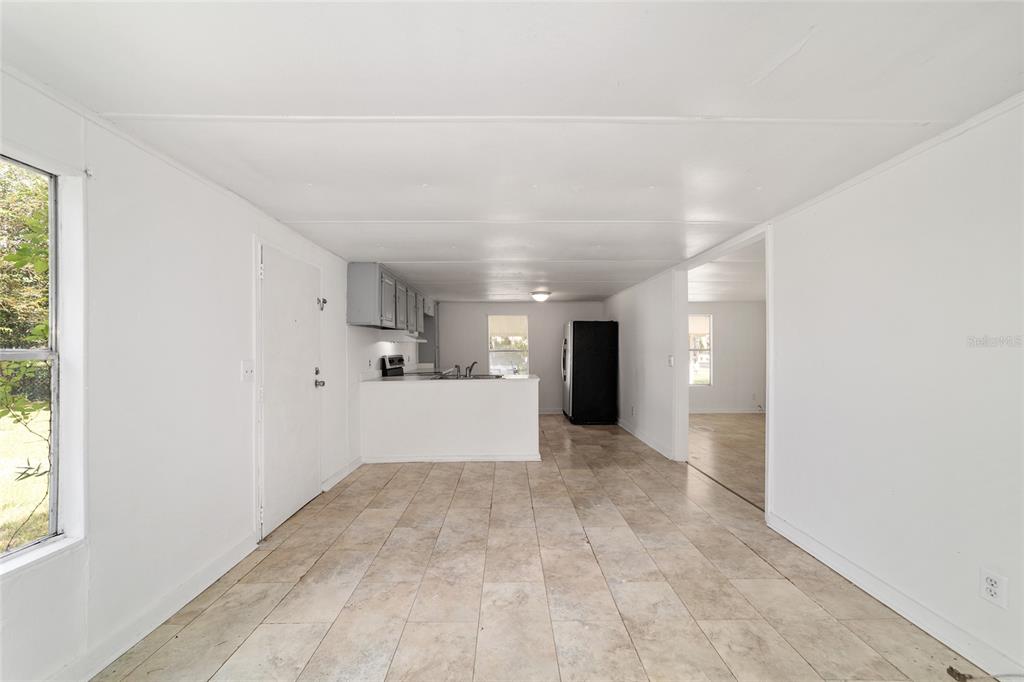 3081 Southwest 90th Street Ocala, FL 34476 - Photo 20 of 34 a view of a big room with wooden floor and windows