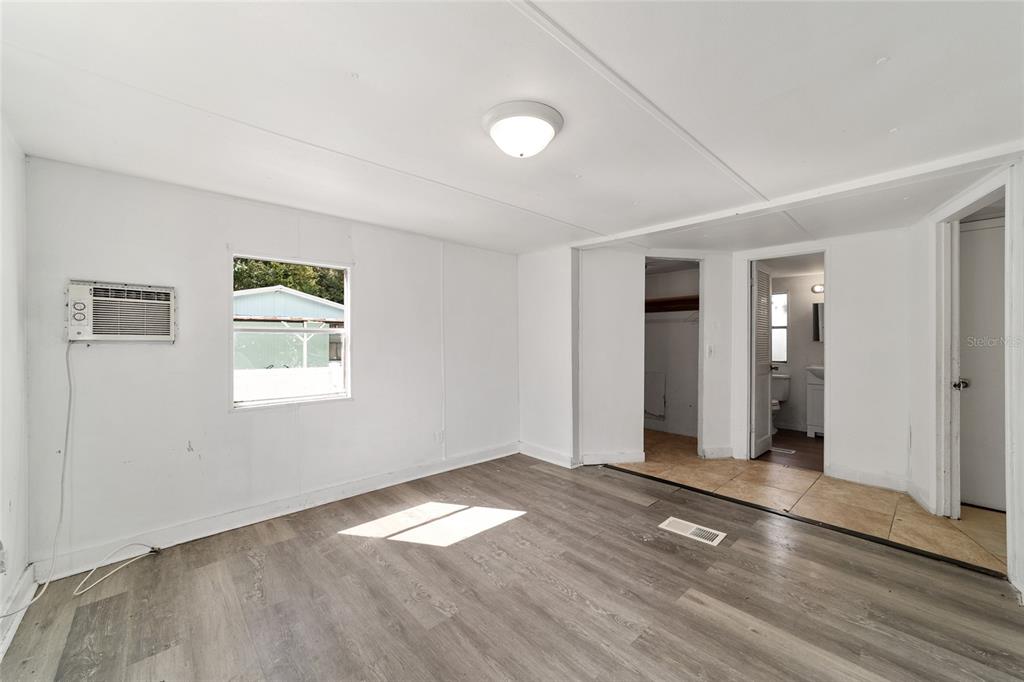 3081 Southwest 90th Street Ocala, FL 34476 - Photo 24 of 34 an empty room with window and wooden floor