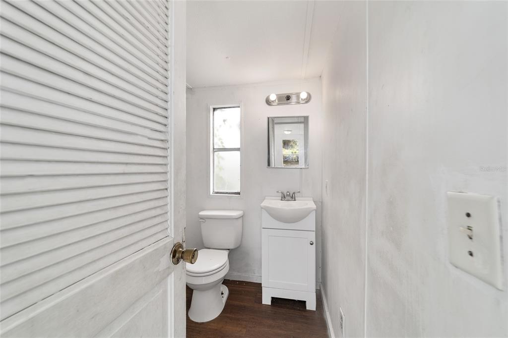 3081 Southwest 90th Street Ocala, FL 34476 - Photo 25 of 34 a bathroom with a toilet a sink and mirror