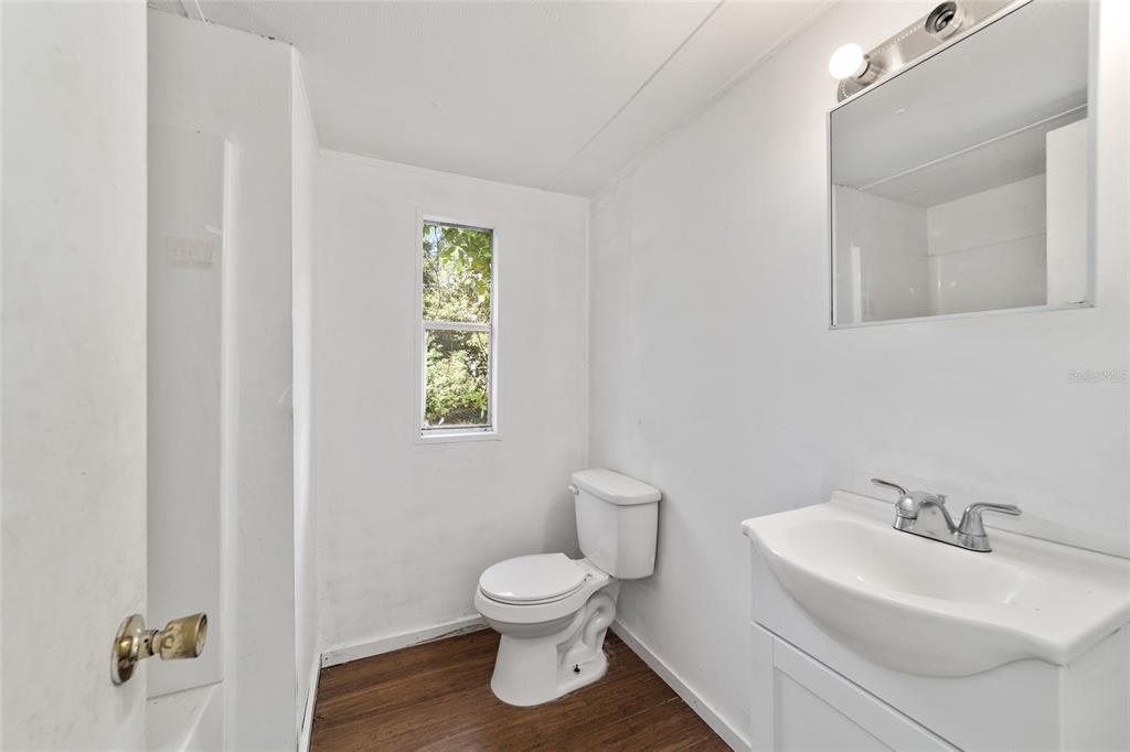 3081 Southwest 90th Street Ocala, FL 34476 - Photo 26 of 34 a bathroom with a toilet sink and mirror
