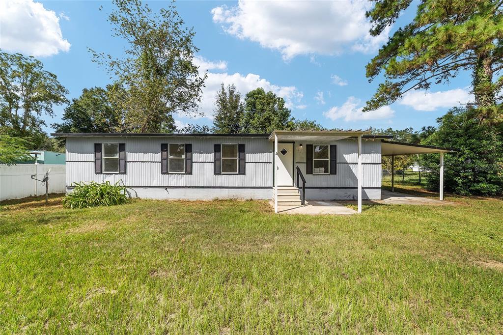3081 Southwest 90th Street Ocala, FL 34476 - Photo 4 of 34 front view of a house with a big yard