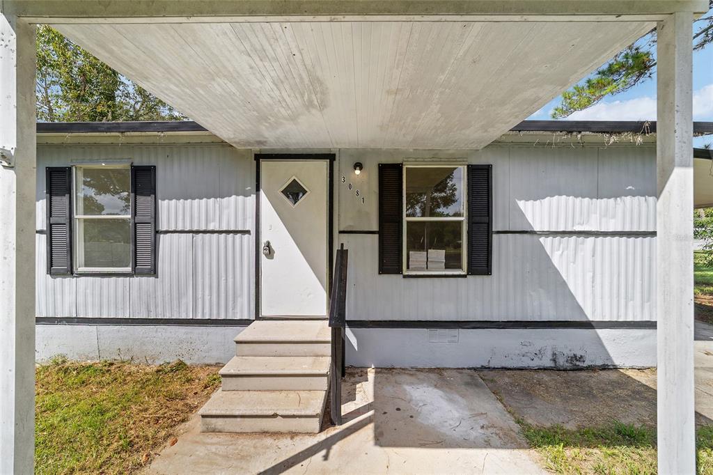 3081 Southwest 90th Street Ocala, FL 34476 - Photo 6 of 34 a view of a house with wooden floor and a potted plant