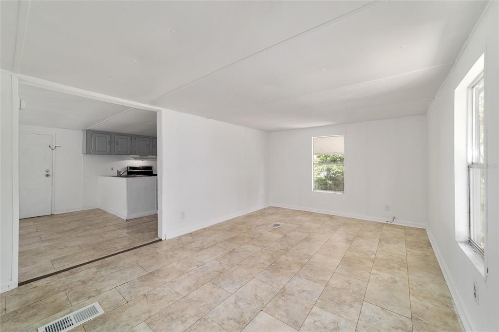 3081 Southwest 90th Street Ocala, FL 34476 - Photo 7 of 34 an empty room with windows and entrance to other room