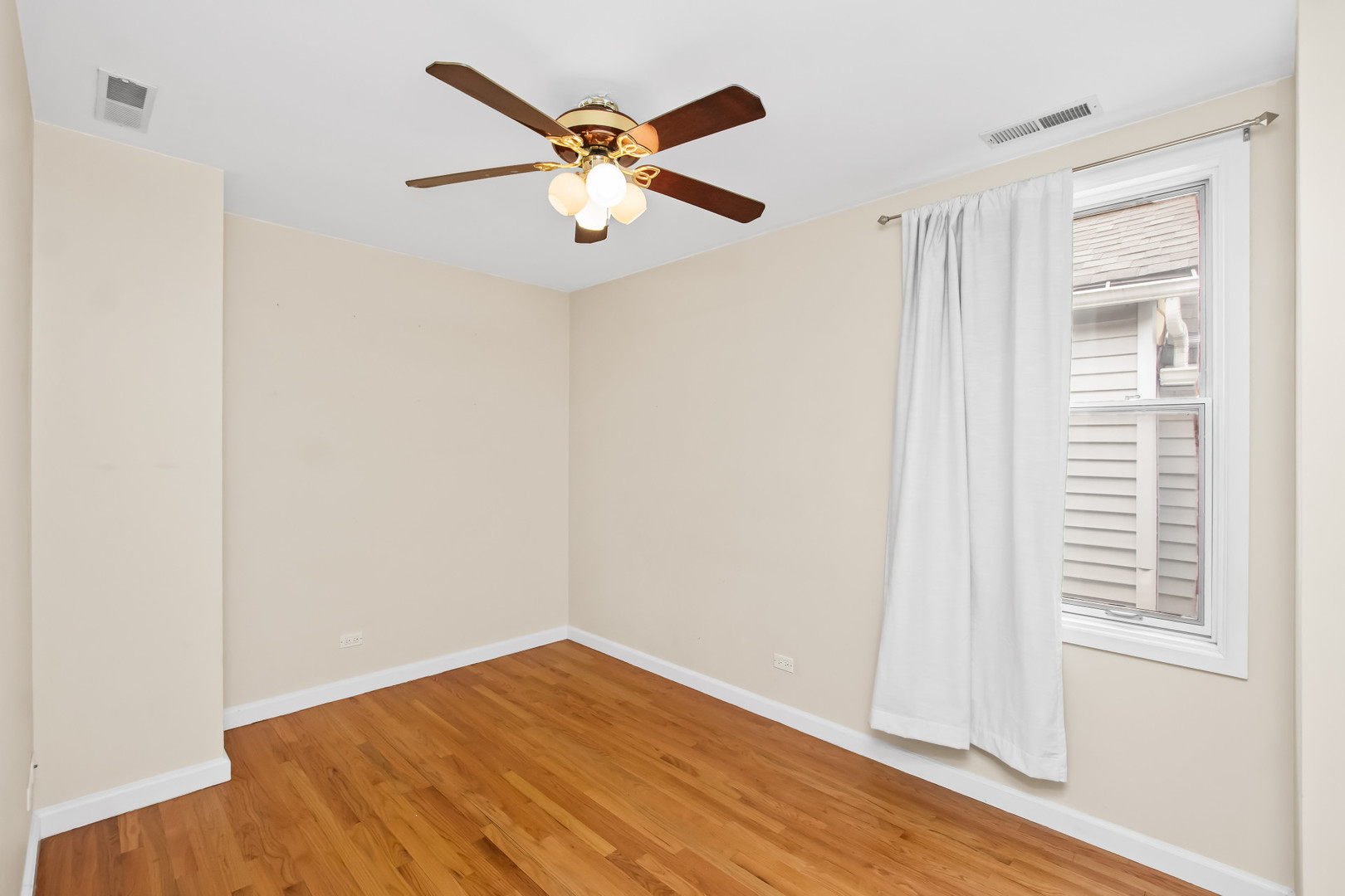 2238 West 21st Place Chicago, IL 60608 - Photo 9 of 37 an empty room with wooden floor and windows