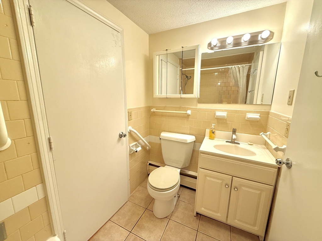 276 Main Street, Unit 3C Acton, MA 01720 - Photo 11 of 12 a bathroom with a sink and a mirror