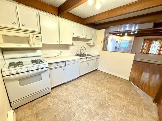 a kitchen with granite countertop a sink and a stove
