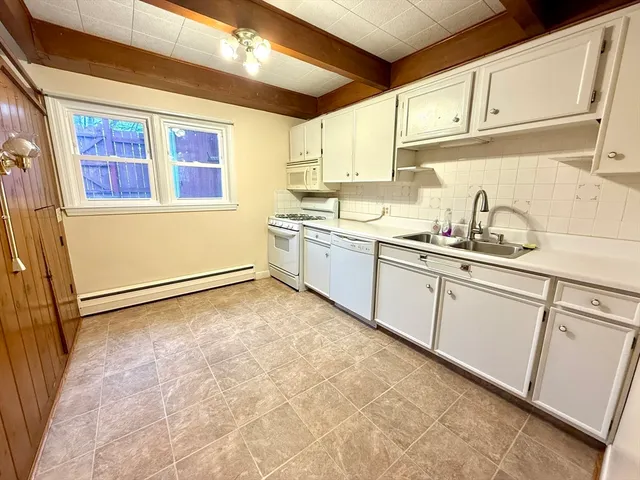 a kitchen with granite countertop a sink and cabinets