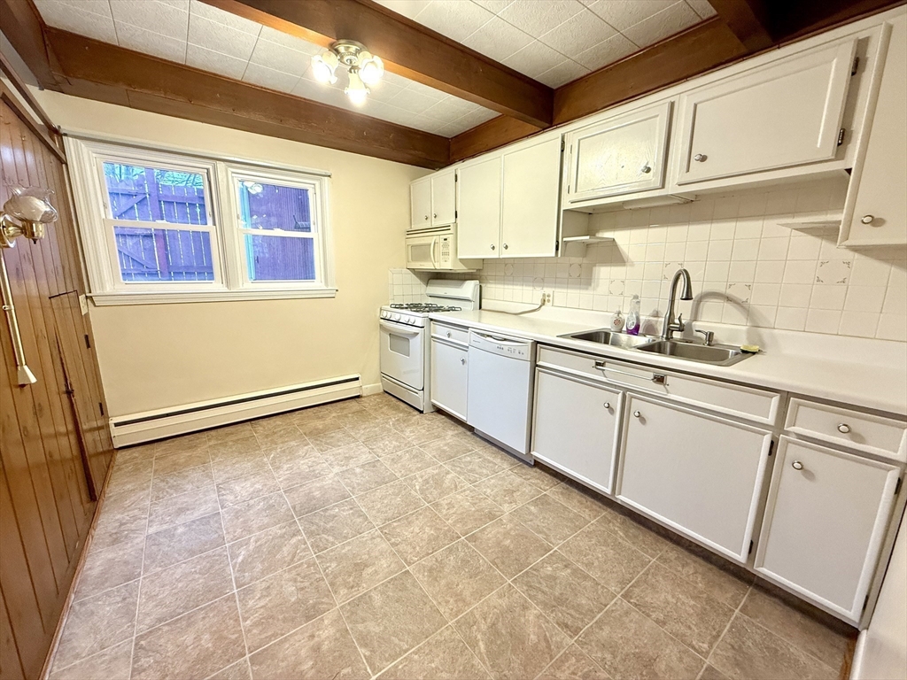 276 Main Street, Unit 3C Acton, MA 01720 - Photo 5 of 12 a kitchen with granite countertop a sink and cabinets