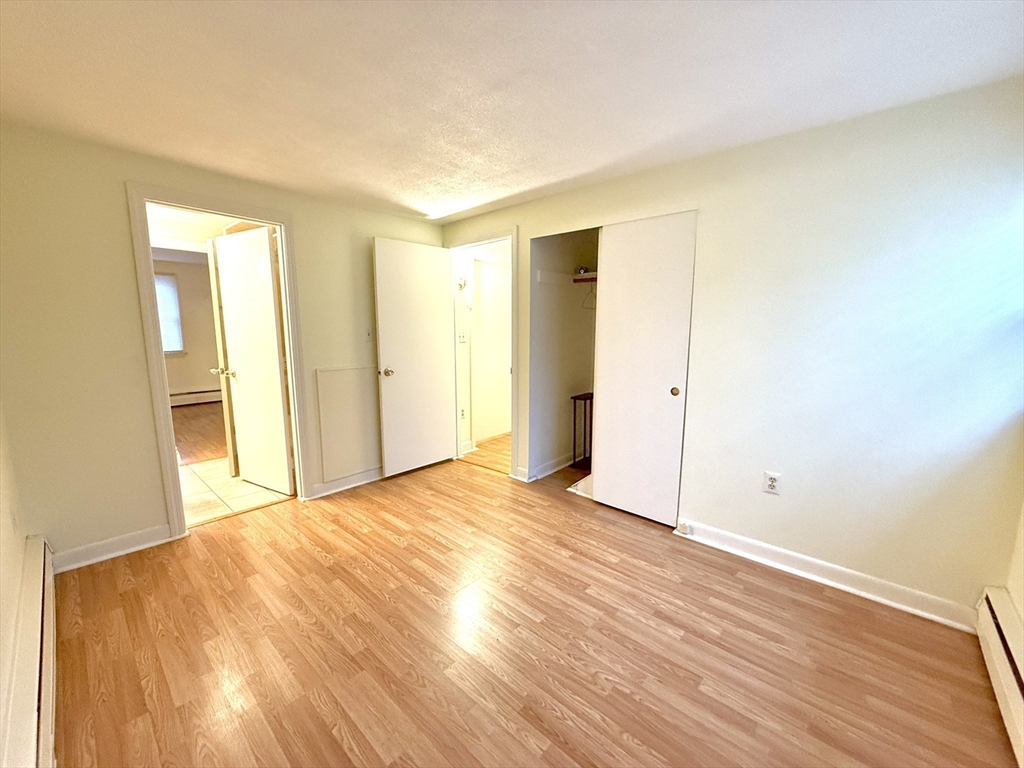 276 Main Street, Unit 3C Acton, MA 01720 - Photo 8 of 12 a view of an empty room with wooden floor