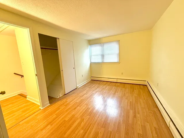 a view of a room with wooden floor and a balcony